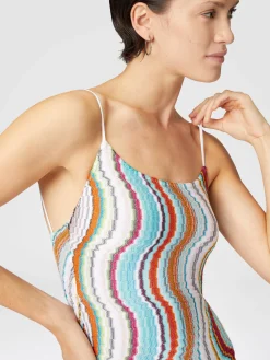 One-piece swimsuit with lamé wave pattern