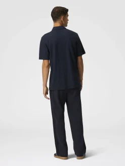 Solid color cotton piqué polo shirt with zigzag embroidery and contrasting detail
